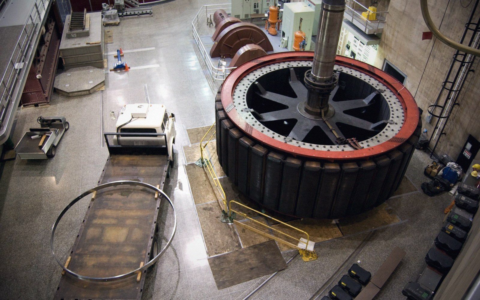 A hydroelectric turbine hall interior, generator casings in a row